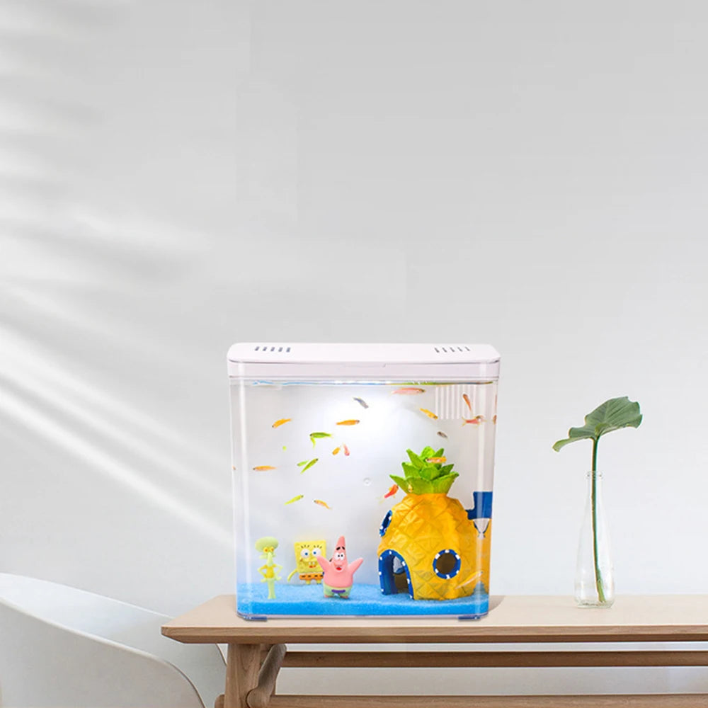 Small fish tank with pineapple-shaped house and cartoon characters on a wooden table.