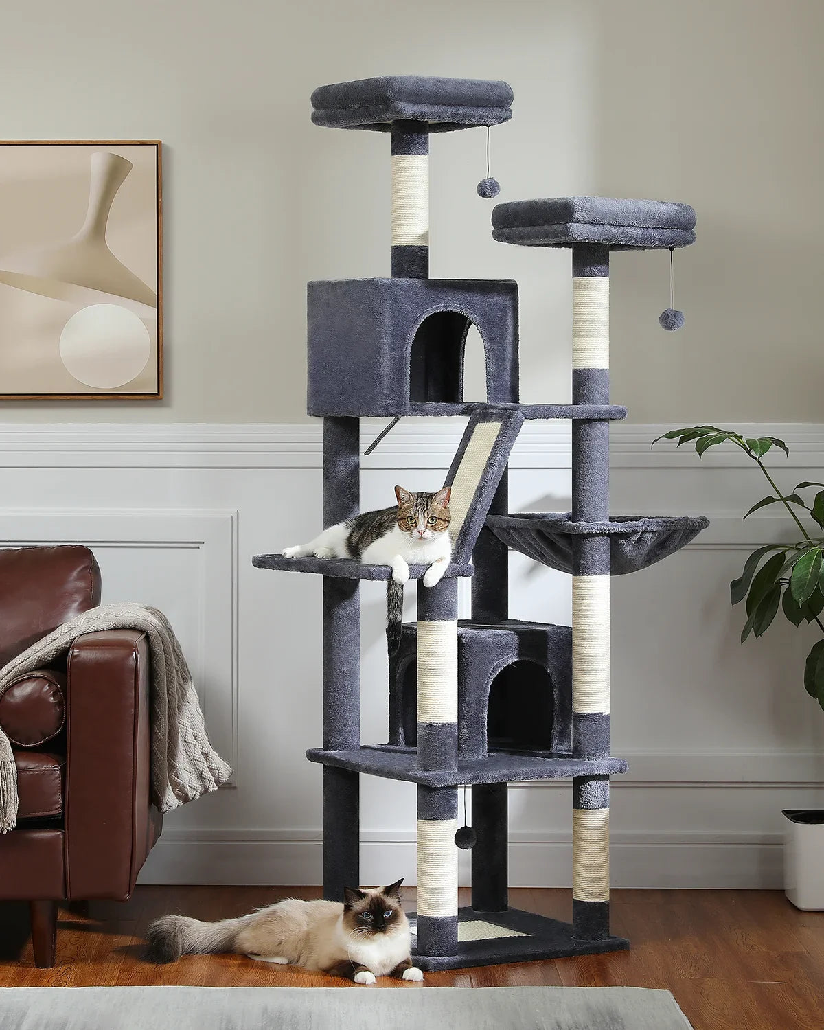 Cat tree with multiple levels and a cat sitting on it in a living room.