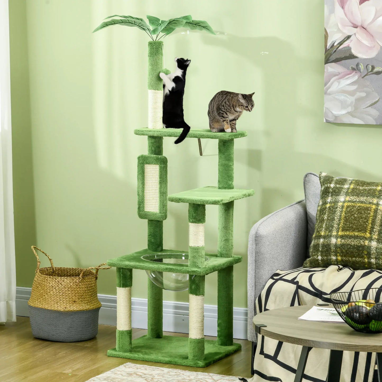 Green cat tree with two cats on a light green wall background