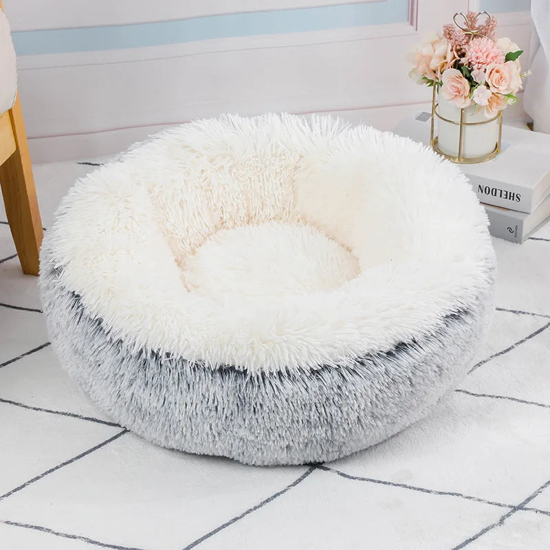 Fluffy white pet bed on a checkered floor with a vase of flowers in the background