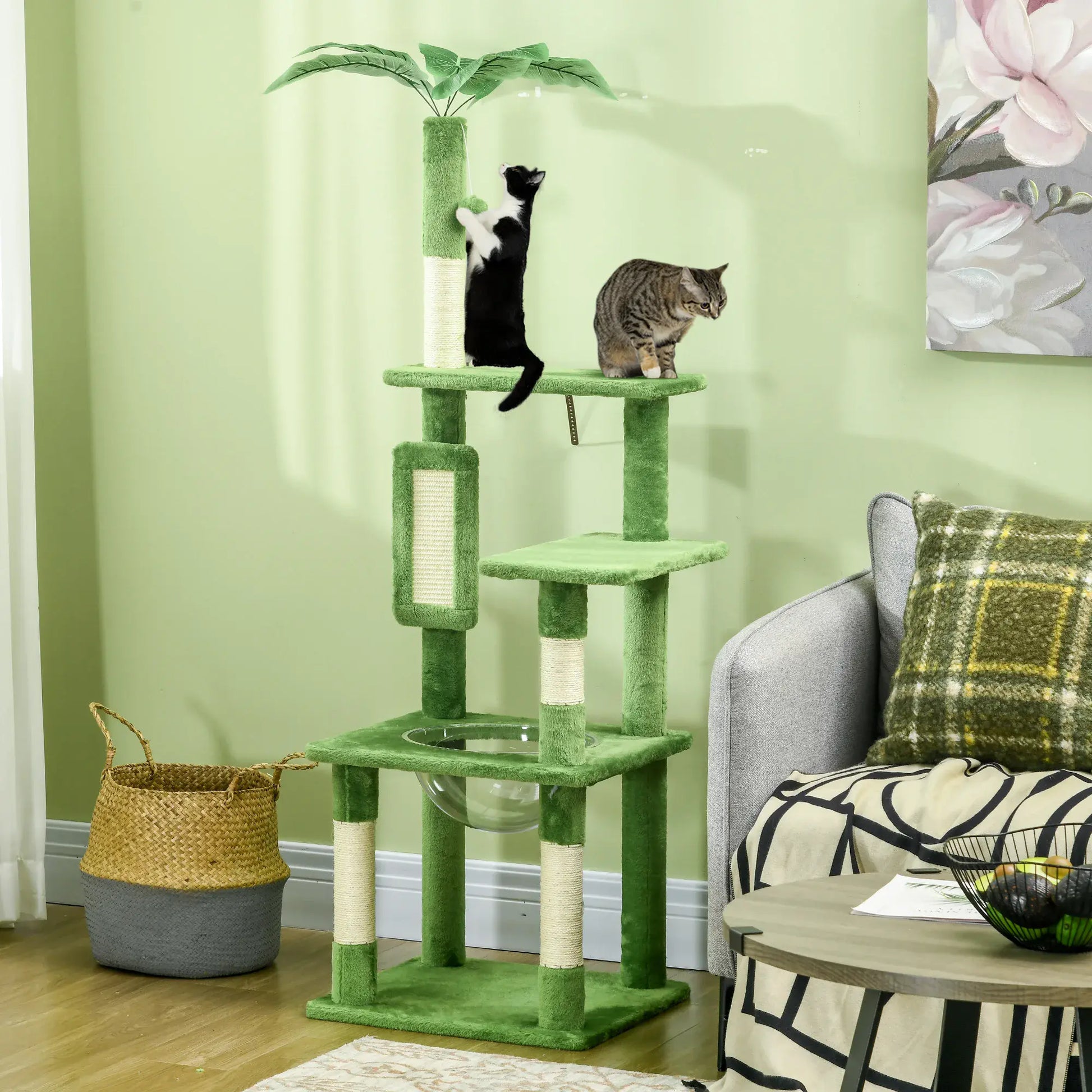 Green cat tree with two cats on a light green wall background